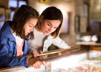 Mother and daughter looking at museum display