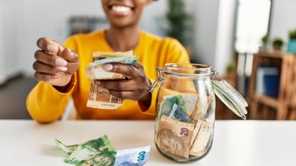 Woman holding South African Rands