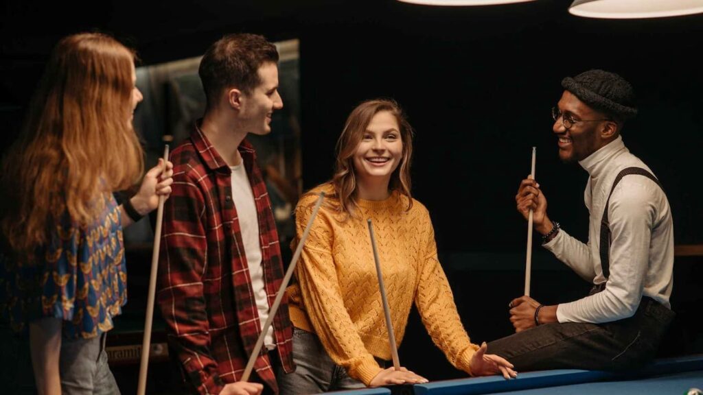 Nightlife bar, friends playing pool