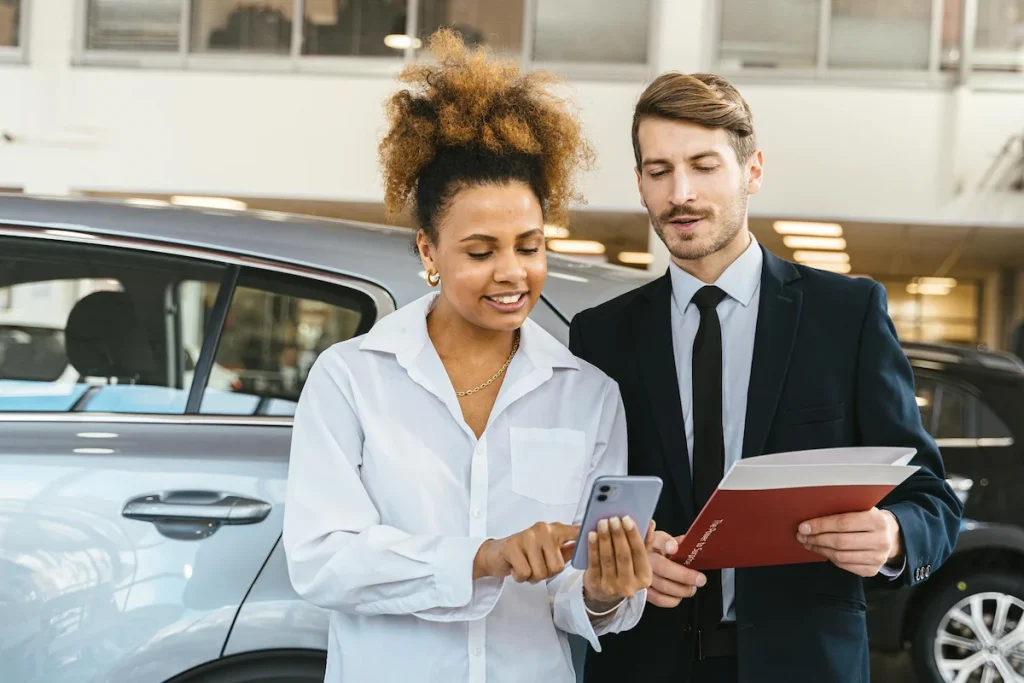 Man and Woman Looing at a Phone Beside a Car - Cape Town Car Rentals