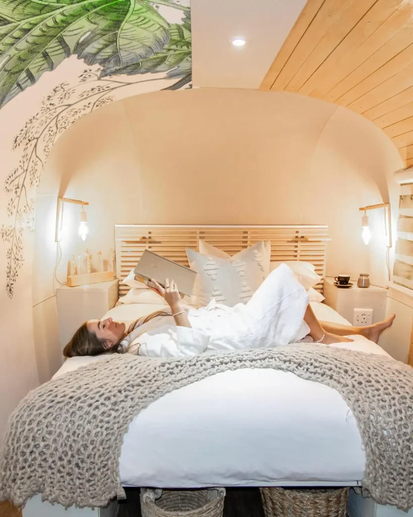 Woman Lying on Bed in Luxury Trailer - The Grand Daddy Boutique Hotel, Cape Town SA