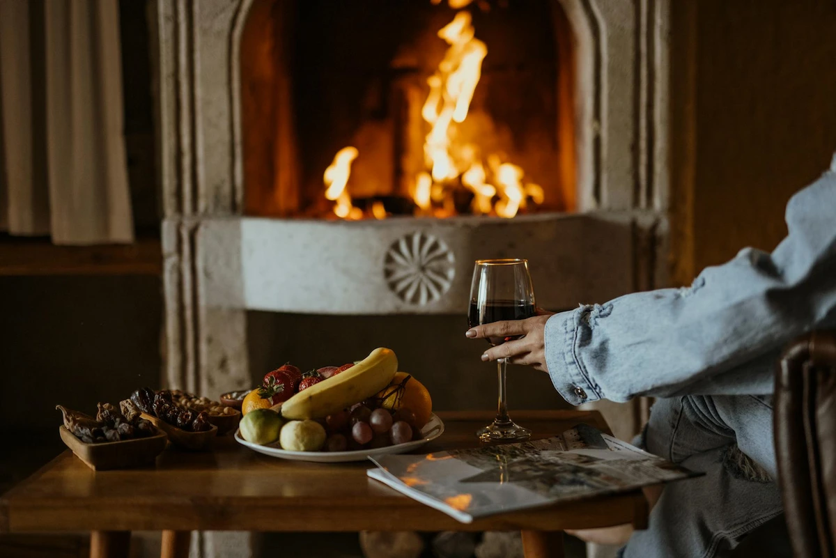 Wine and Fruit Platter Beside a Fireplace - Winelands Restaurants with Fireplaces